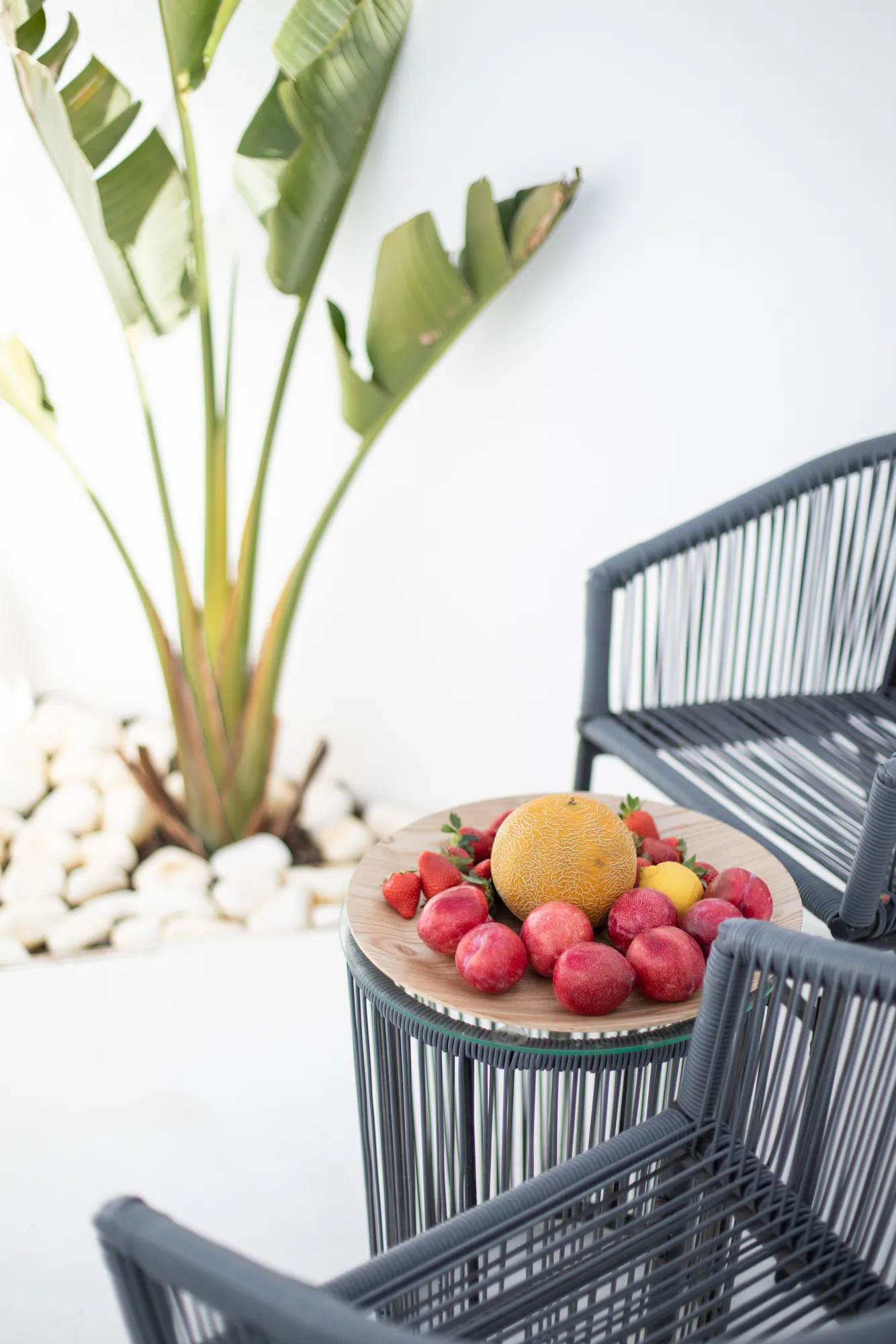 Rope chairs with a bowl of fresh fruit on the terrace